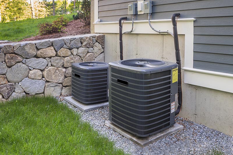 Heating and air conditioning HVAC systems seen outside while preforming home inspection services